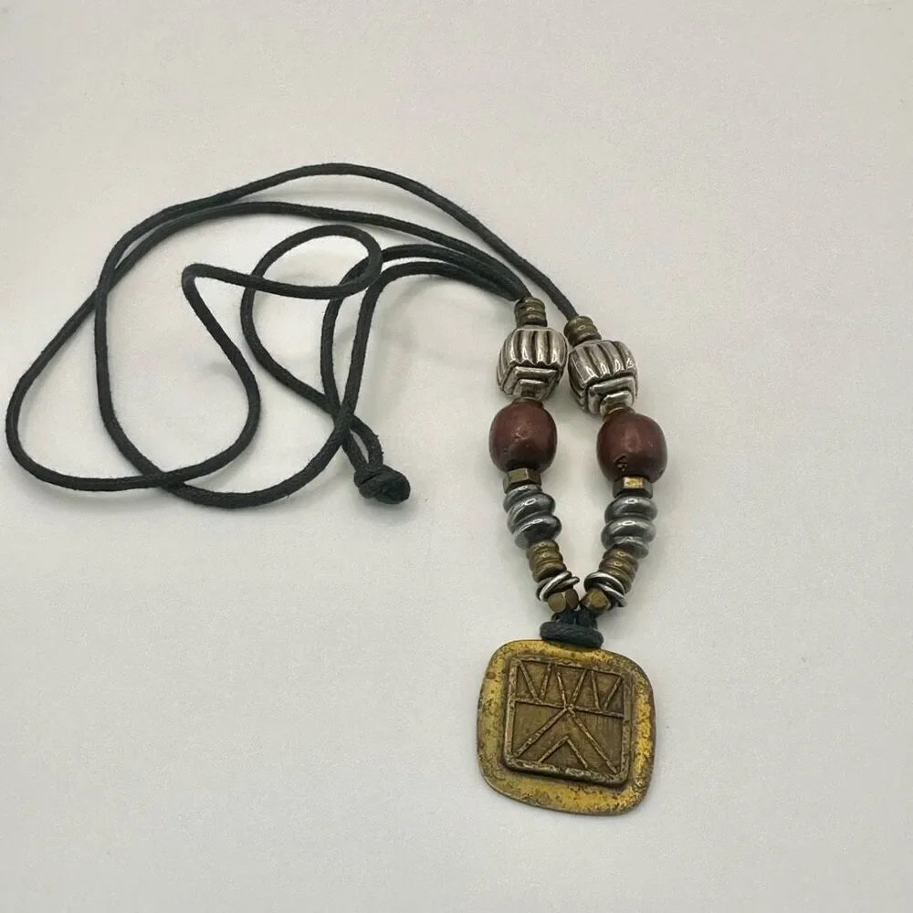 Baer SF sterling silver and brass pendant necklace on black cord